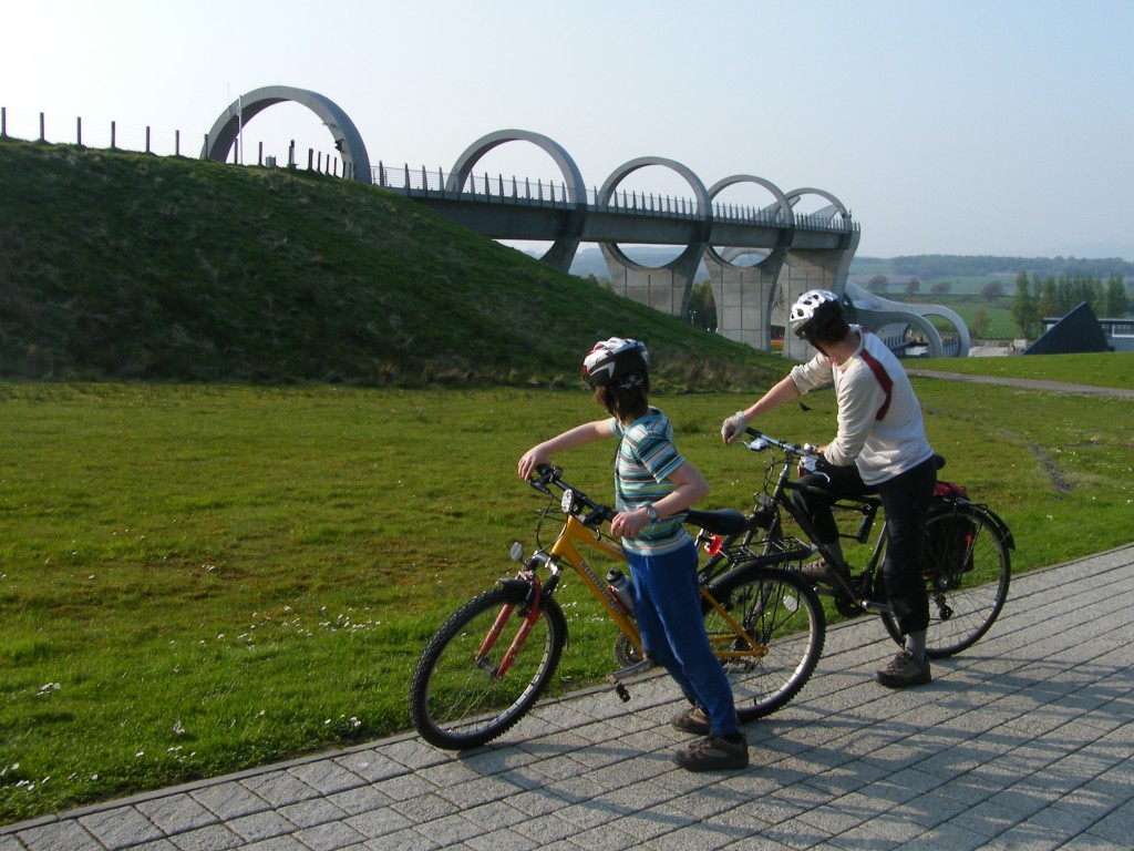 Callum and Chris cycling past the Falkirk Wheel